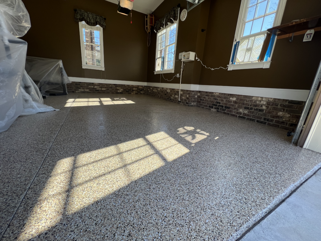 gray flake epoxy garage floor with sealed concrete surface installed for residential garage use