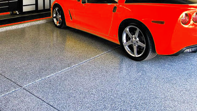 red corvette parked on epoxy flooring in garage