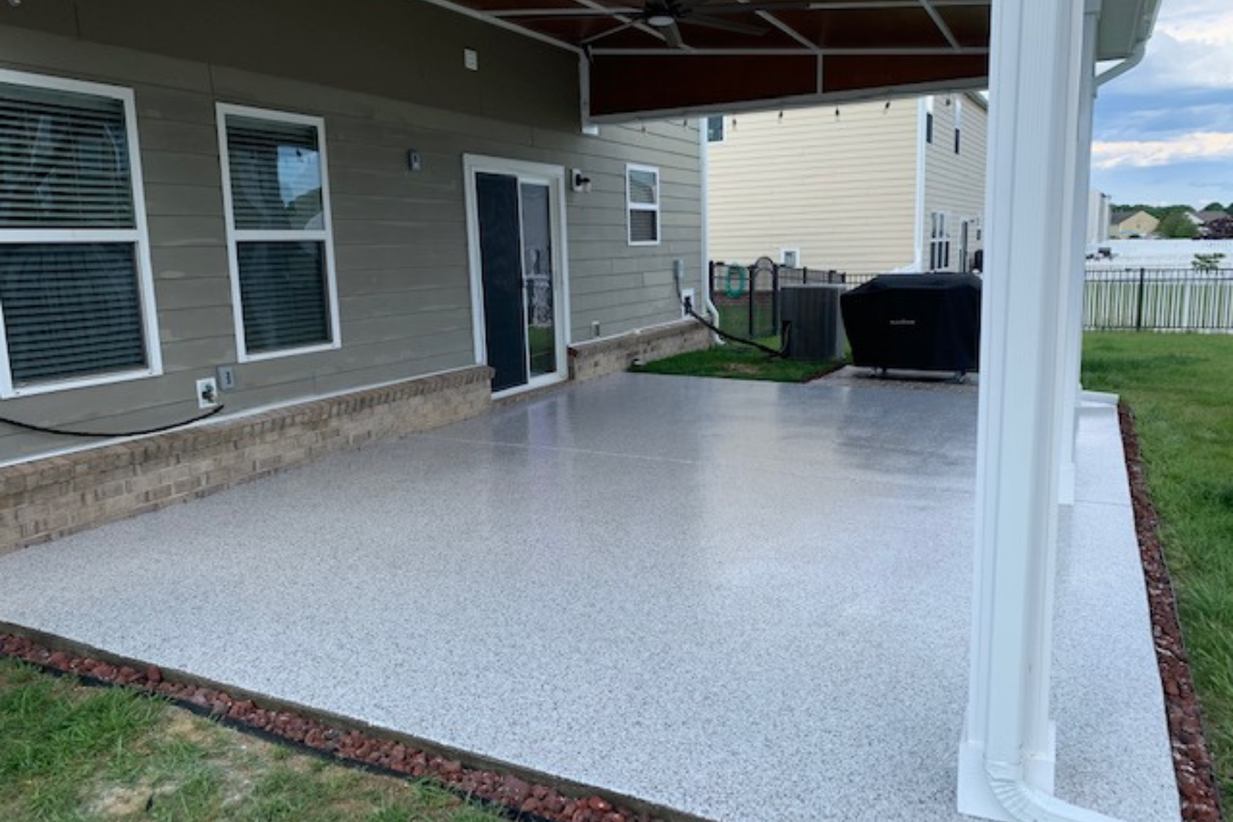 covered outdoor concrete slab with shoreline gray flake epoxy floor coating installed
