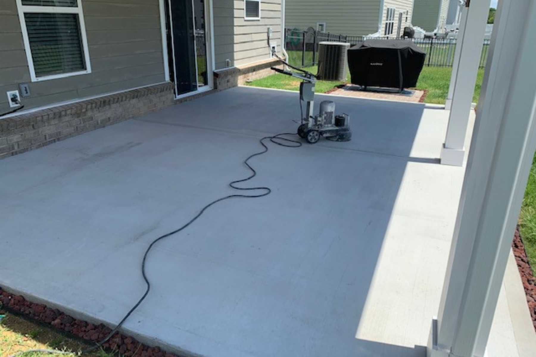 covered residential concrete slab being mechanically prepped before epoxy floor coating installation