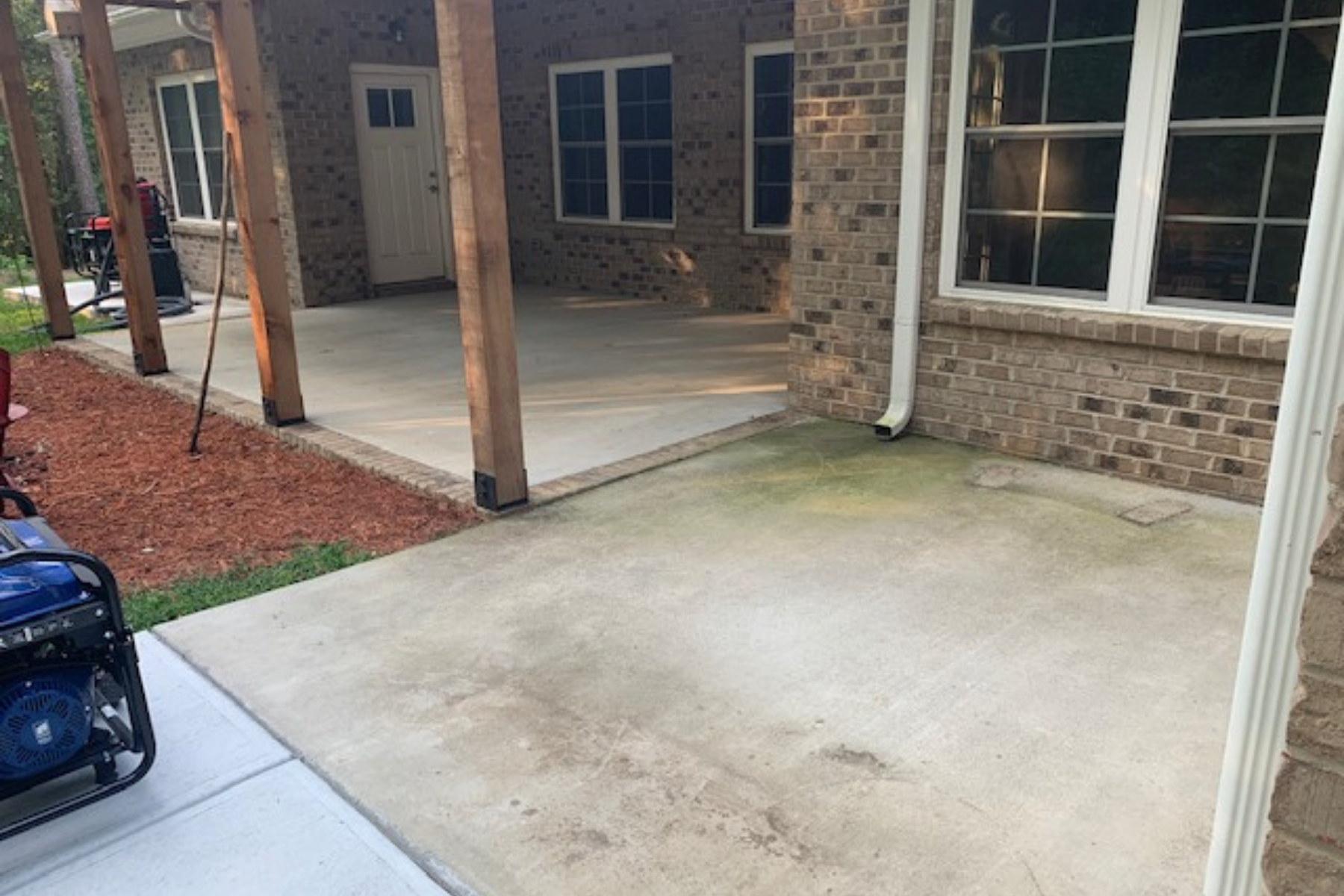 covered brick patio and walkway concrete before epoxy application adjacent concrete walkway and covered patio showing surface wear before epoxy installation