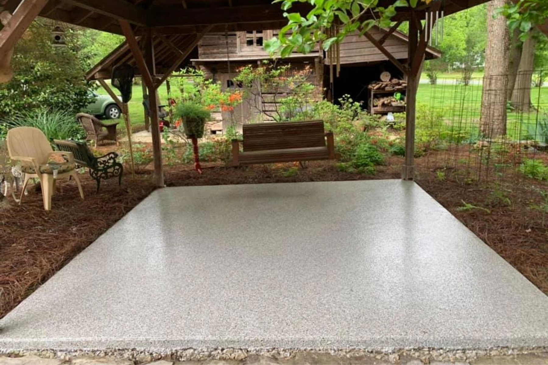 epoxy coated concrete deck with light stone flake finish under covered outdoor structure