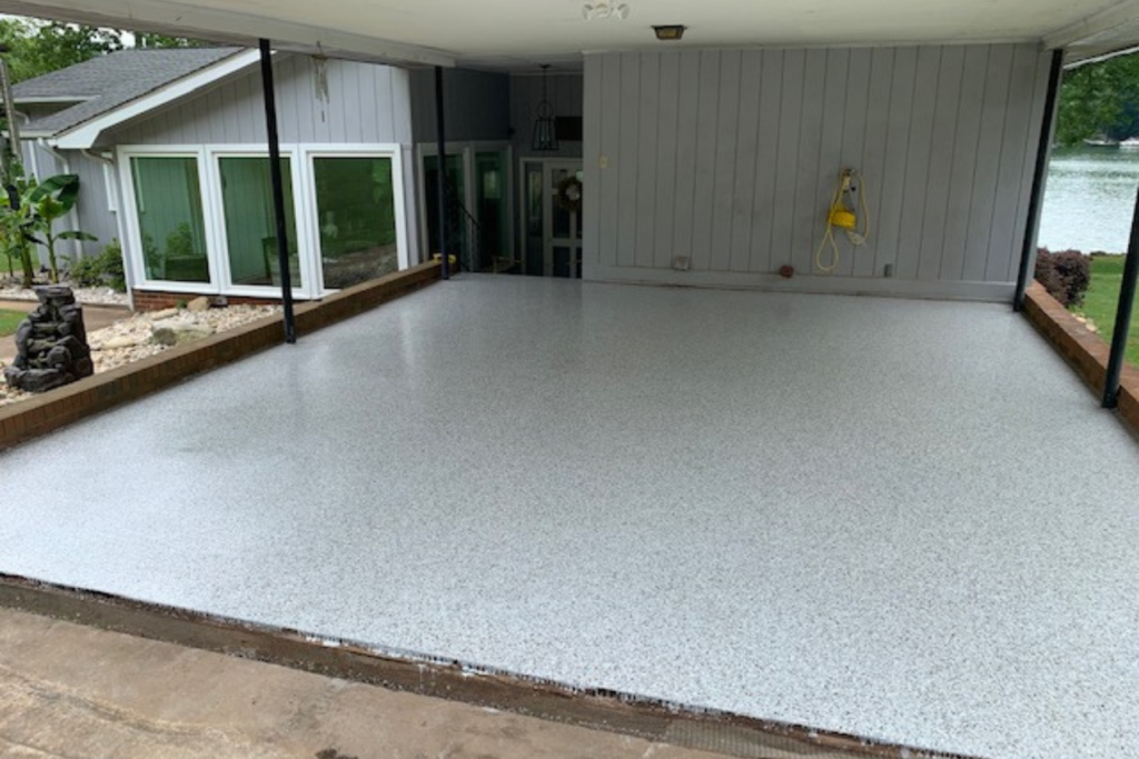 covered carport epoxy floor with pearl gray flake finish near waterfront home