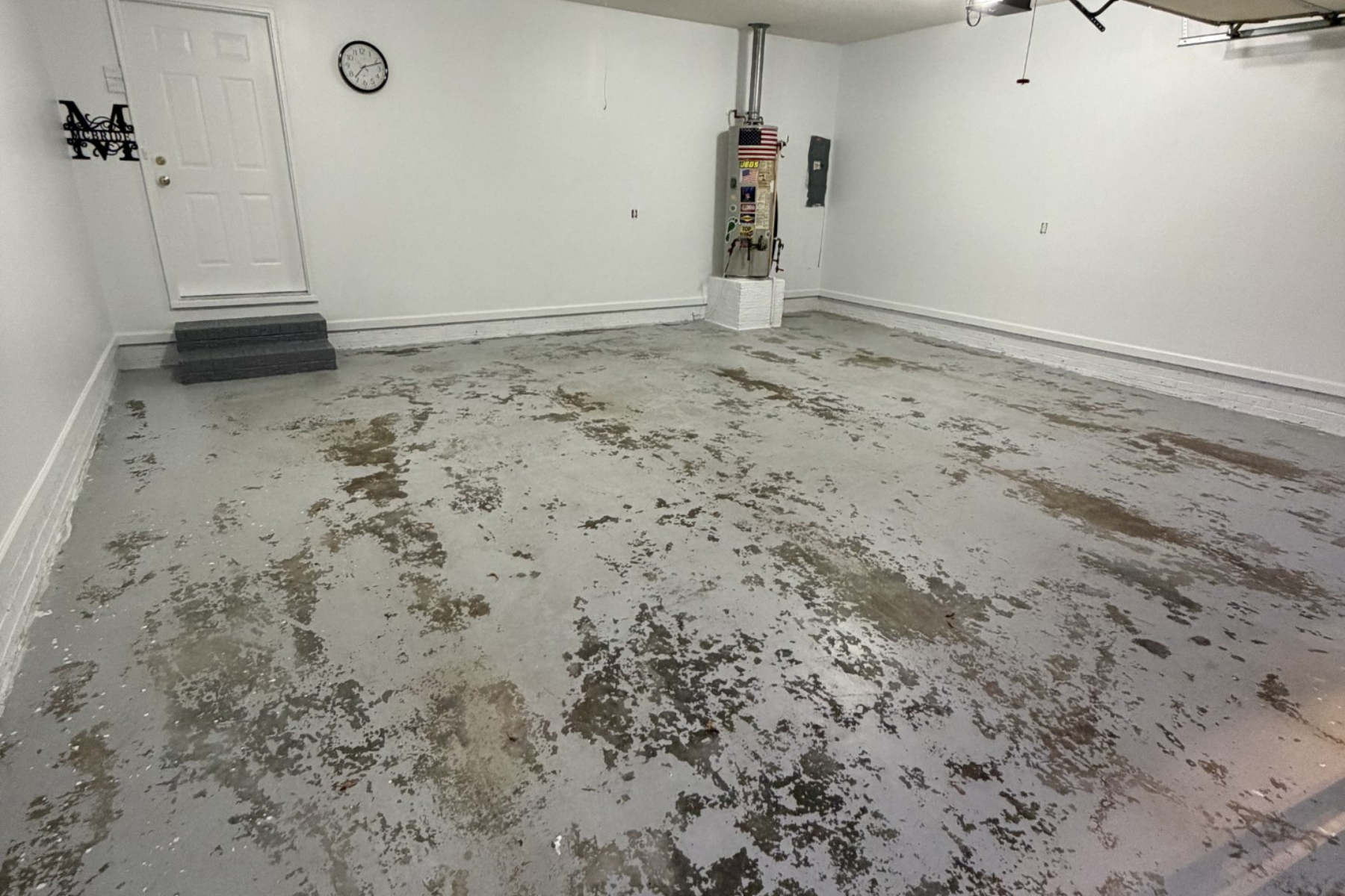 residential garage with peeling concrete floor and surface deterioration prior to epoxy floor installation