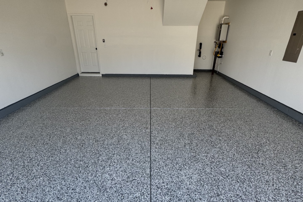 residential garage with gray speckled epoxy floor coating and sealed concrete surface