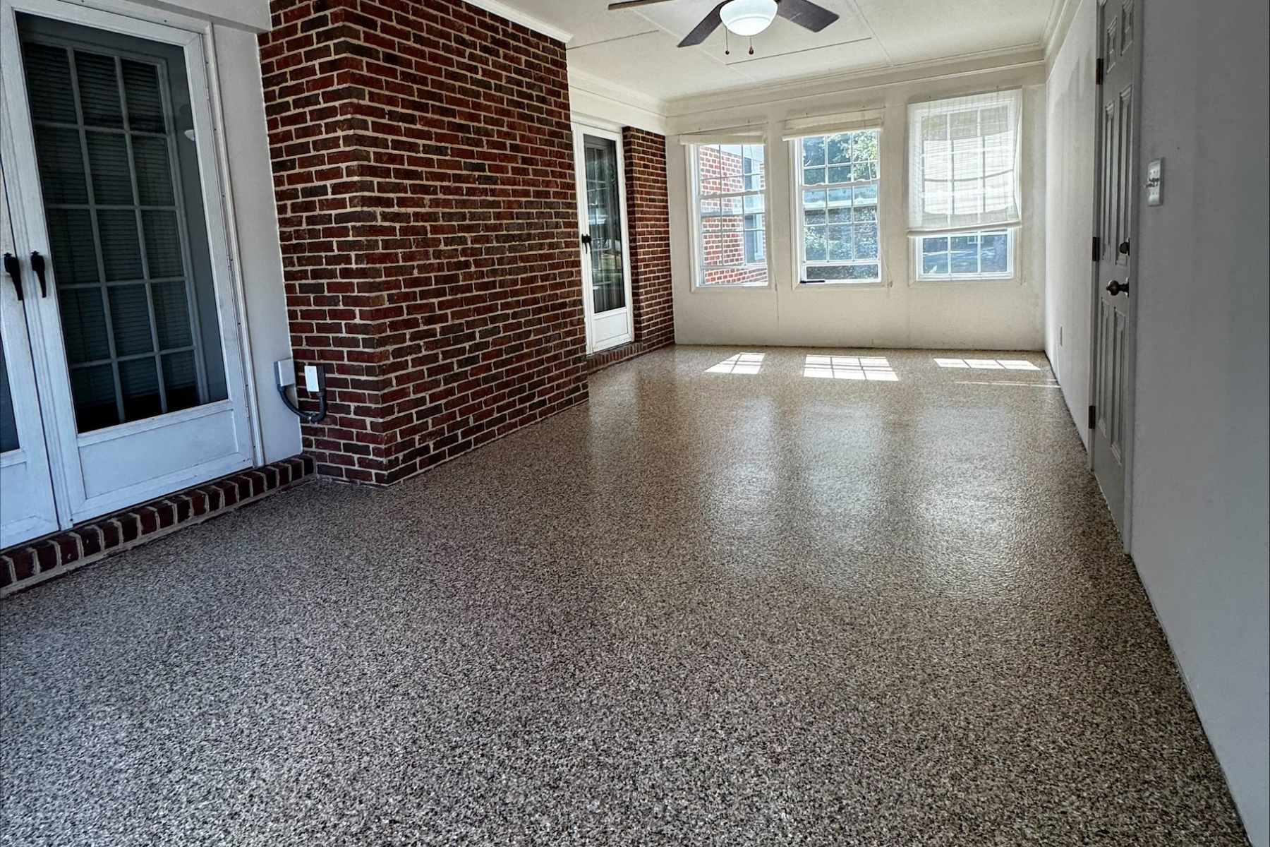 covered brick porch with freshly installed speckled epoxy floor coating and smooth sealed finish