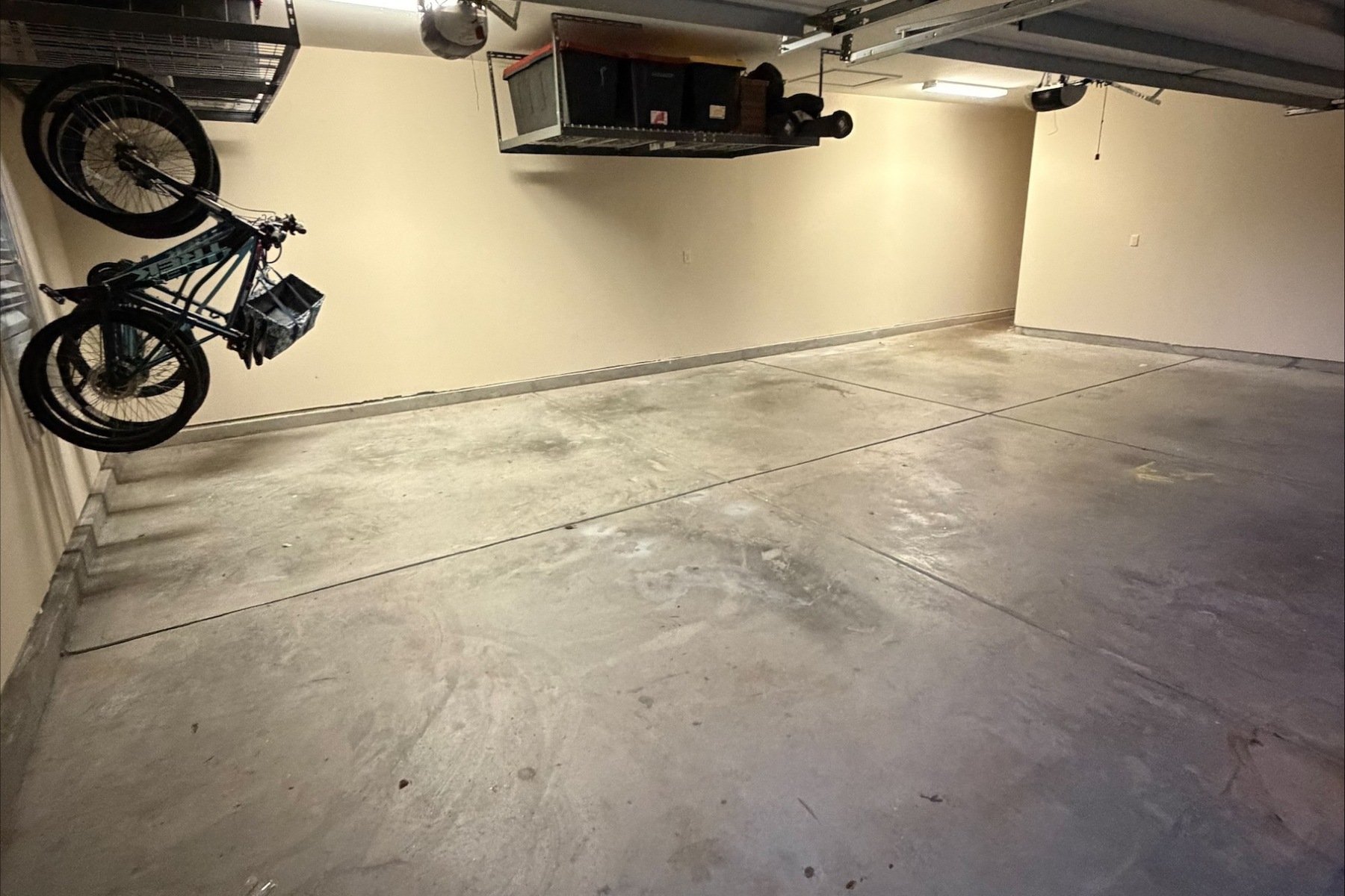 residential garage with bare concrete floor showing surface wear and staining before epoxy installation